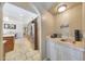 Wet bar area featuring a sink, cabinets and tile countertops at 6911 E Thunderbird Rd, Scottsdale, AZ 85254