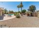 Lush backyard with a pool, palm trees, and seating area, perfect for entertaining at 6931 E Pershing Ave, Scottsdale, AZ 85254