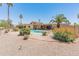 A view of the back of the house, kidney-shaped pool, desert landscaping, and orange bougainvillea at 6931 E Pershing Ave, Scottsdale, AZ 85254