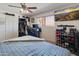 Cozy bedroom with ceiling fan, closet, and large screen television; furnished with a comfortable bed and stylish decor at 6931 E Pershing Ave, Scottsdale, AZ 85254