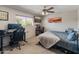 Bedroom with a bed and desk, offering a versatile space for relaxation and productivity at 6931 E Pershing Ave, Scottsdale, AZ 85254