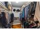Organized walk-in closet filled with clothes and shoes, providing ample storage space at 6931 E Pershing Ave, Scottsdale, AZ 85254