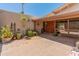 A charming front entrance with double wooden doors is framed by lush planters and desert landscaping at 6931 E Pershing Ave, Scottsdale, AZ 85254