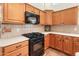 Updated kitchen featuring black appliances and light wood cabinets at 6931 E Pershing Ave, Scottsdale, AZ 85254