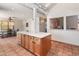 Open kitchen with tile floor, an island, and a view to another living area at 6931 E Pershing Ave, Scottsdale, AZ 85254
