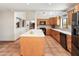 Spacious kitchen features an island, tile flooring and sleek, black appliances at 6931 E Pershing Ave, Scottsdale, AZ 85254