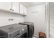 Convenient laundry room with modern washer and dryer, cabinetry, and storage at 6931 E Pershing Ave, Scottsdale, AZ 85254