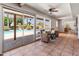Bright living room with large sliding doors offering views of the pool and patio, complemented by comfortable seating at 6931 E Pershing Ave, Scottsdale, AZ 85254