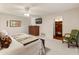 Spacious main bedroom boasts a ceiling fan, dresser with television, and an ensuite bathroom with walk-in closet at 6931 E Pershing Ave, Scottsdale, AZ 85254