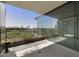 A modern balcony with views, greenery, and glass doors into the home's interior at 7120 E Kierland Blvd # 316, Scottsdale, AZ 85254