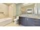 Bathroom showcases tiled walls, modern vanity and bathtub with shower combination at 7120 E Kierland Blvd # 316, Scottsdale, AZ 85254