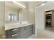 Contemporary bathroom with elegant vanity and adjacent laundry with stacked washer and dryer at 7120 E Kierland Blvd # 316, Scottsdale, AZ 85254