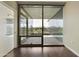 A light-filled bedroom with dark hardwood floors, a large doorway and glass doors to the balcony at 7120 E Kierland Blvd # 316, Scottsdale, AZ 85254