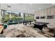 Bright game room features a pool table, ping pong table, and floor to ceiling windows at 7120 E Kierland Blvd # 316, Scottsdale, AZ 85254