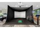 Modern golf simulator room with black netting and a screen for a realistic golfing experience at 7120 E Kierland Blvd # 316, Scottsdale, AZ 85254