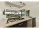 Close-up of modern kitchen with stainless steel appliances, gas cooktop, and outdoor views at 7120 E Kierland Blvd # 316, Scottsdale, AZ 85254