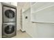 Bright and airy laundry and closet space with stacked washer and dryer and shelving at 7120 E Kierland Blvd # 316, Scottsdale, AZ 85254