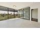 Bright living room featuring tile floors and a wall of windows overlooking the outdoors at 7120 E Kierland Blvd # 316, Scottsdale, AZ 85254
