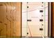 Bright squash court with glass door and wood paneling, offering a private and dedicated space for racquet sports at 7120 E Kierland Blvd # 316, Scottsdale, AZ 85254