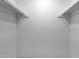 Empty all-white walk-in closet features shelving at 8020 E Thomas Rd # 313, Scottsdale, AZ 85251