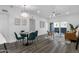 Dining room with hardwood floors, modern light fixture, and sliding glass doors to the balcony at 8020 E Thomas Rd # 313, Scottsdale, AZ 85251