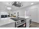 Open concept kitchen features modern appliances and island with range overlooking the living area at 8020 E Thomas Rd # 313, Scottsdale, AZ 85251
