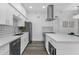 Stylish kitchen with white cabinets, sleek appliances, and quartz countertops with a modern design at 8020 E Thomas Rd # 313, Scottsdale, AZ 85251