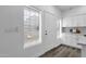 Bright kitchen features white cabinets, mosaic backsplash, and wood-look flooring at 8020 E Thomas Rd # 313, Scottsdale, AZ 85251