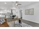 Open concept living and kitchen area with hardwood floors, modern lighting and neutral decor at 8020 E Thomas Rd # 313, Scottsdale, AZ 85251