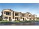 Attractive townhouse-style homes with a combination of light tan and dark tan finishes and a modern architectural design at 8149 E Petunia Ave # 1060, Mesa, AZ 85212