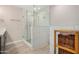 Elegant bathroom featuring a glass-enclosed shower with white tiled walls and wood look floors at 8713 E Citrus Way, Scottsdale, AZ 85250
