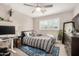 Cozy bedroom featuring a ceiling fan, a comfortable bed, and a stylish work-from-home desk setup at 8713 E Citrus Way, Scottsdale, AZ 85250