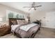 Comfortable bedroom featuring a ceiling fan, desk, and warm, neutral decor at 8713 E Citrus Way, Scottsdale, AZ 85250