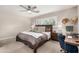 Comfortable bedroom featuring a ceiling fan, desk, and warm, neutral decor at 8713 E Citrus Way, Scottsdale, AZ 85250