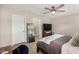 Comfortable bedroom featuring a ceiling fan and access to a private bathroom at 8713 E Citrus Way, Scottsdale, AZ 85250