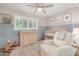 Charming Bedroom featuring modern decor, a crib, dresser, and comfortable chair at 8713 E Citrus Way, Scottsdale, AZ 85250