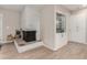 Dining area with white painted brick fireplace, built-in cabinet, and wood-look floors at 8713 E Citrus Way, Scottsdale, AZ 85250