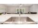 Dining area showcasing a large island, stainless steel sink, and a view of the backyard and dining area at 8713 E Citrus Way, Scottsdale, AZ 85250