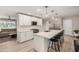 Bright, open kitchen features white cabinets, a large island with seating, and modern stainless steel appliances at 8713 E Citrus Way, Scottsdale, AZ 85250