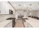 Spacious kitchen featuring white cabinets, stainless steel appliances, a central island, and wood-look flooring at 8713 E Citrus Way, Scottsdale, AZ 85250