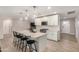 Modern kitchen with white cabinetry, a large island with seating, stainless steel appliances, and sleek pendant lighting at 8713 E Citrus Way, Scottsdale, AZ 85250