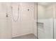 Modern shower showcasing tiled walls, niche, a rainfall showerhead, and handheld sprayer at 8713 E Citrus Way, Scottsdale, AZ 85250