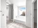 Bright bathroom with soaking tub and shower, adjacent to the walk-in closet at 8831 N 63Rd Dr, Glendale, AZ 85302