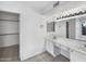 Bathroom with dual sinks, vanity, ample lighting, and a walk-in closet at 8831 N 63Rd Dr, Glendale, AZ 85302