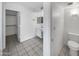 Well-lit bathroom includes a vanity sink, toilet, and a spacious walk-in closet at 8831 N 63Rd Dr, Glendale, AZ 85302
