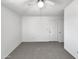 Comfortable carpeted bedroom with bright interior, fan and closet doors at 8831 N 63Rd Dr, Glendale, AZ 85302