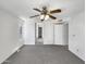 Spacious bedroom features neutral carpet, ceiling fan with lighting, and ample closet space at 8831 N 63Rd Dr, Glendale, AZ 85302