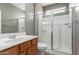 Bathroom featuring a standing shower with glass door and wood vanity at 9 S 195Th Ln, Buckeye, AZ 85326