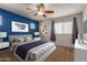 Bright bedroom with a stylish blue accent wall and ample natural light at 9 S 195Th Ln, Buckeye, AZ 85326