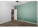 Neutral bedroom with a ceiling fan, green accent wall and carpet flooring at 9 S 195Th Ln, Buckeye, AZ 85326